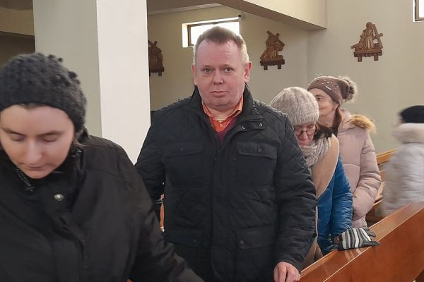 Mieszkańcy wychodzą z ławy kościoła.