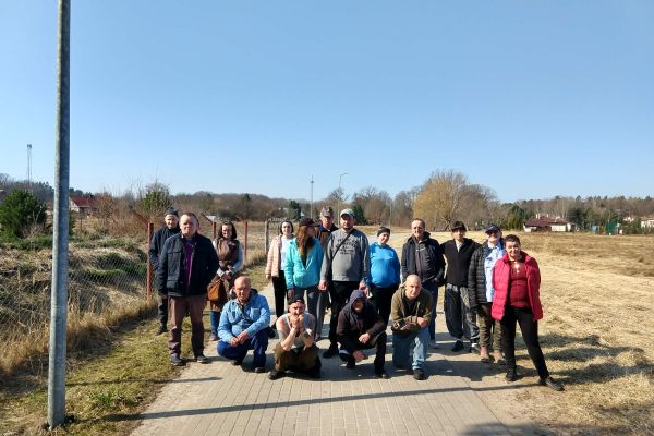 Mieszkańcy spacerują chodnikiem we wiosce.