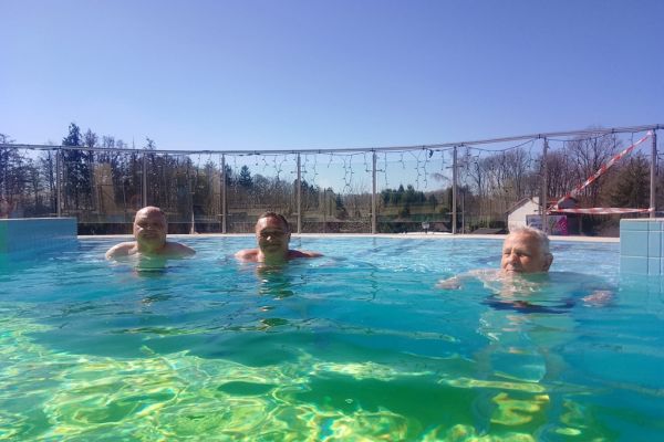 Troje mieszkańców w basenie zewnętrznym.