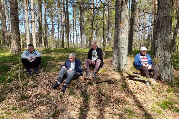 Mieszkańcy siedzą w lesie.