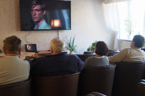 Mieszkańcy oglądaja film.