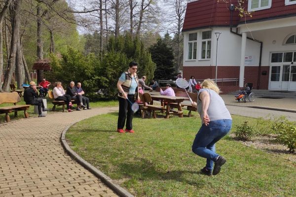 Mieszkanka gra w badmintona podczas grilla.