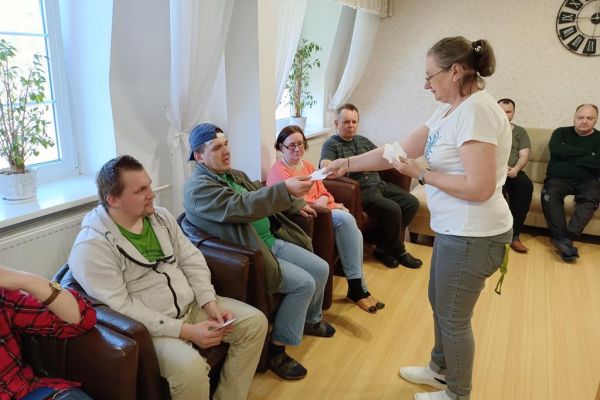 Mieszkańcy dostaja karteczko od prowadzącej.