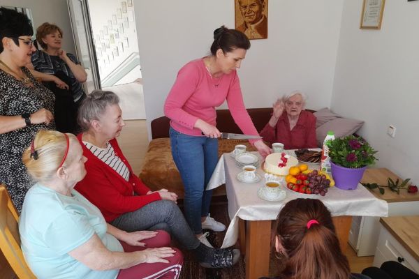 Pracownica kroi tort.