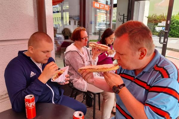 Mieszkańcy jedzący kebaby i zapiekanki.