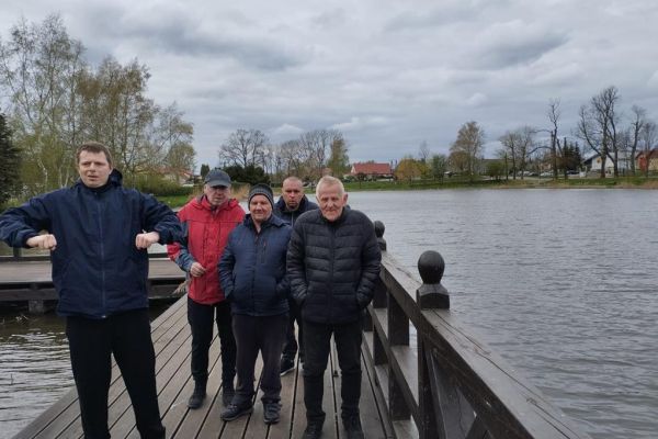 Pięcioro mieszkańców nad jeziorkiem na pomoście.