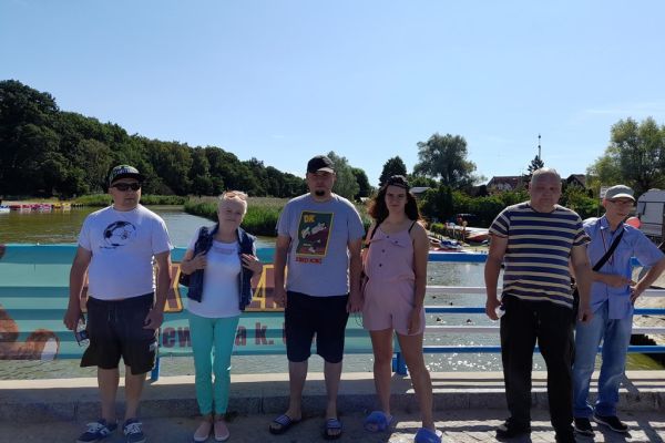 Szescioro mieszkańców stoi na moście nad rzeką.